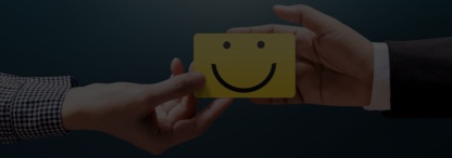 a businessman and a woman exchanging a yellow block on which is a smiley face demonstrating good communication